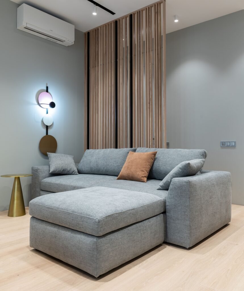 HVAC technician servicing a wall mounted air conditioner in a premium modern living room