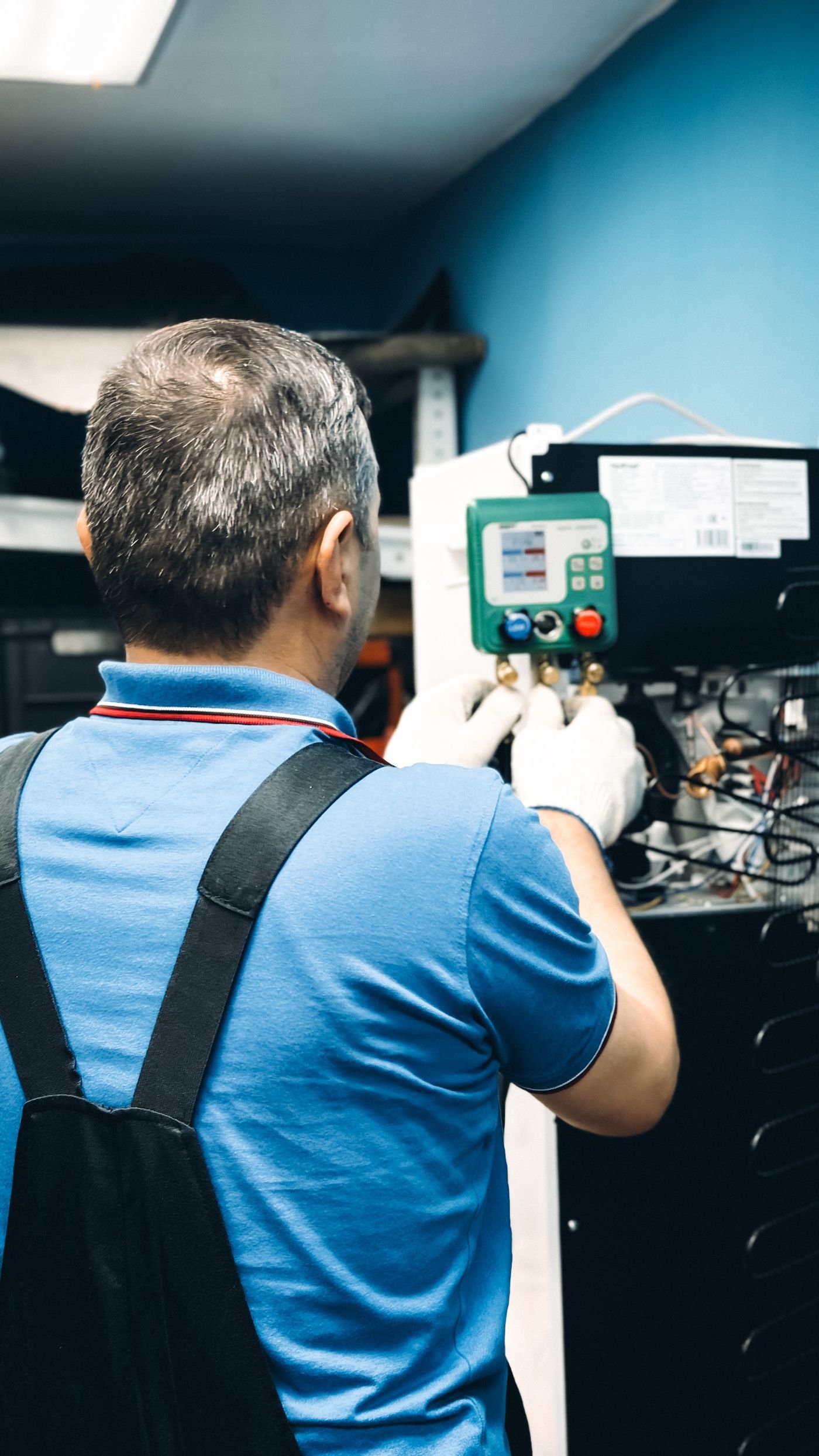 Aircon service cost Perth technician carrying out maintenance