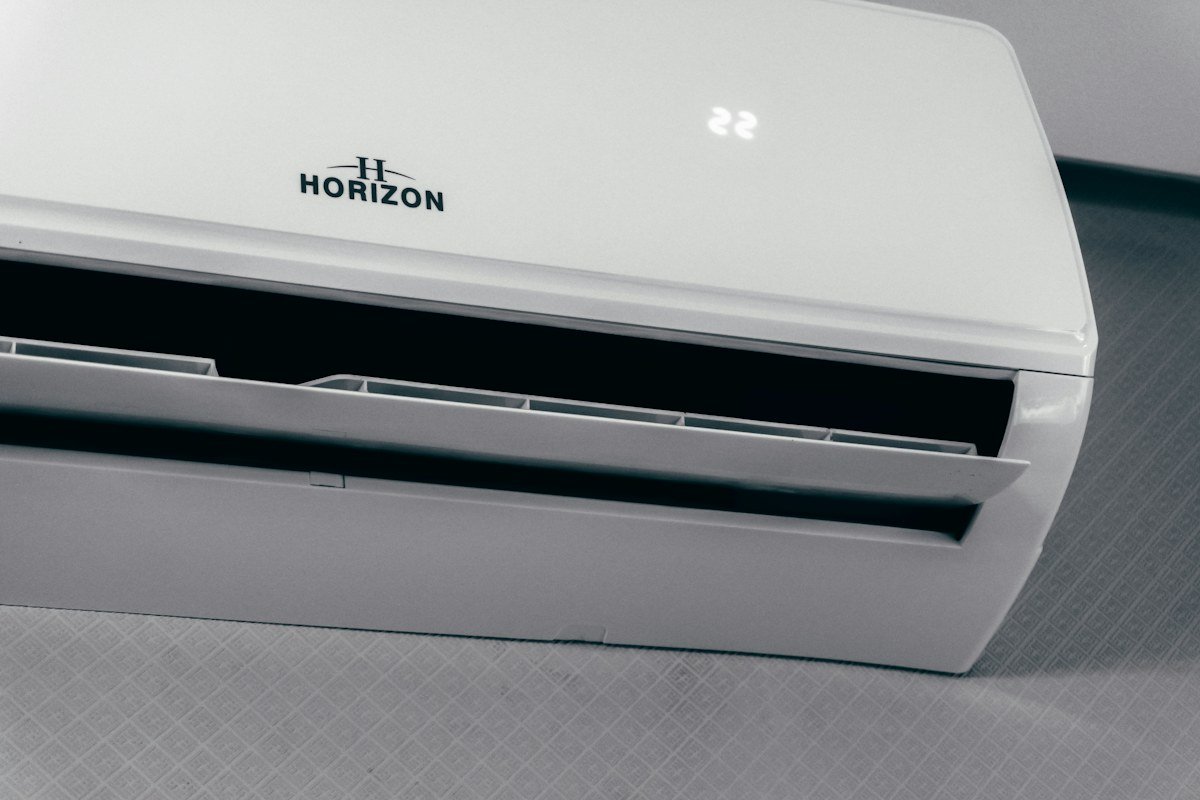 White wall mounted indoor air conditioner displaying 22 degrees